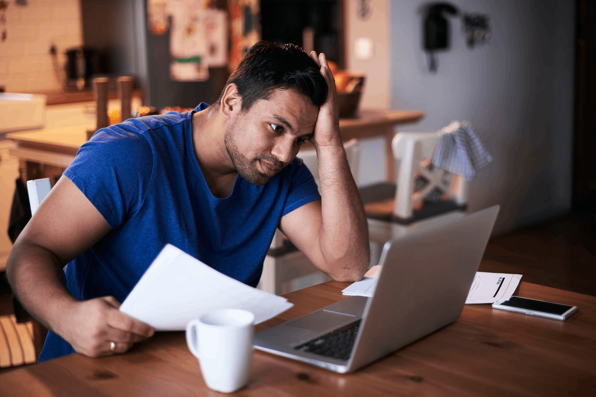 Australian professional working on a laptop at his desk after hours.